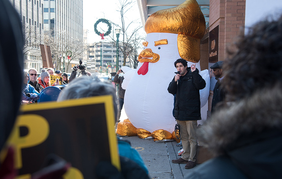 Protesters rally outside Rep. Katko’s office, bringing along a giant chicken resembling President Donald Trump