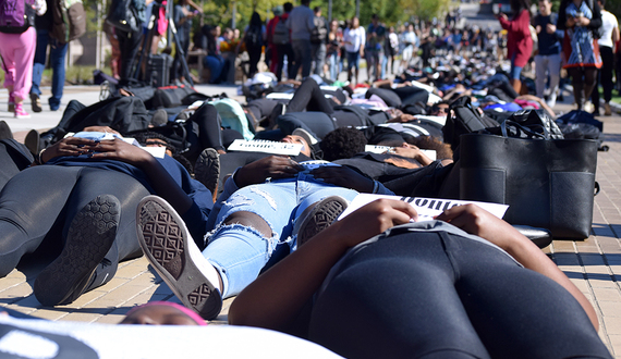 Syracuse University community members stage die-in on University Place promenade