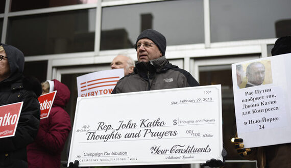 Activists deliver Rep. Katko a check for ‘Thoughts and Prayers’ at gun control protest