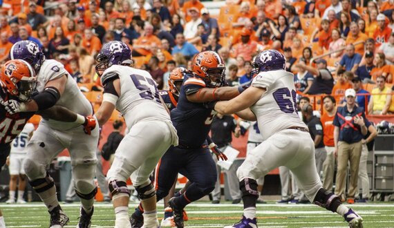 &#8216;Ironman&#8217; Chris Elmore switches between defensive tackle and fullback in 41-3 win over Holy Cross