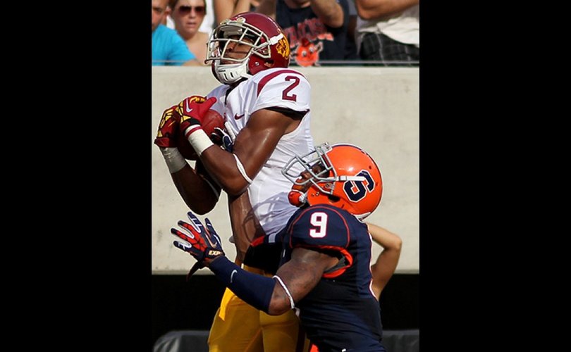 USC wide receiver Robert Woods hauls in a pass over Syracuse cornerback Ri'Shard Anderson in the Trojans' 42-29 win on Saturday. Woods finished with 10 catches for 93 yards and two touchdowns.