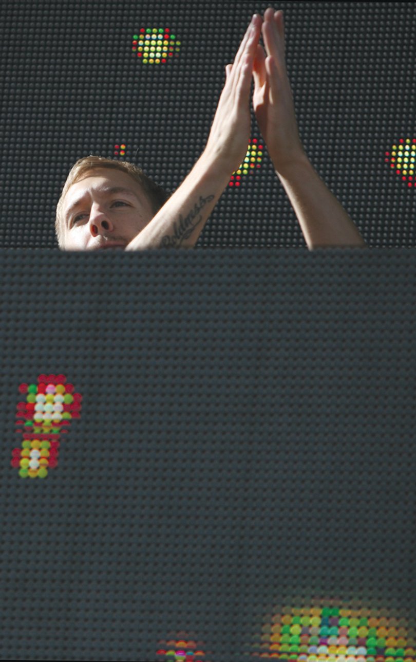 Calvin Harris claps his hands during his set.