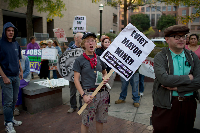 Laura Brown, one of the original members of the Occupy movement in Syracuse, yells at the beginning of the group's march.