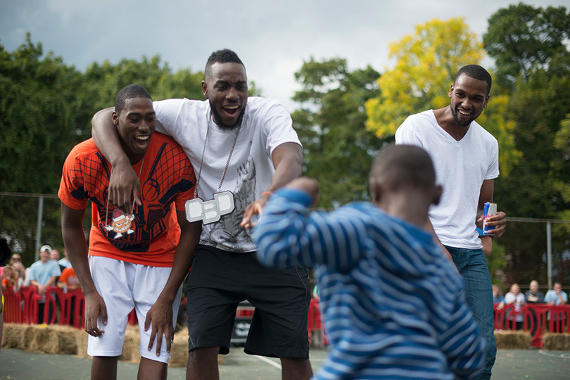 Members of the basketball team watch their opponents during the dance off. The players were guest judges at the event.