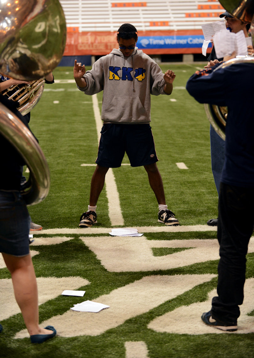 Morgan Edwards, an SU junior, instructs the sousaphone section.