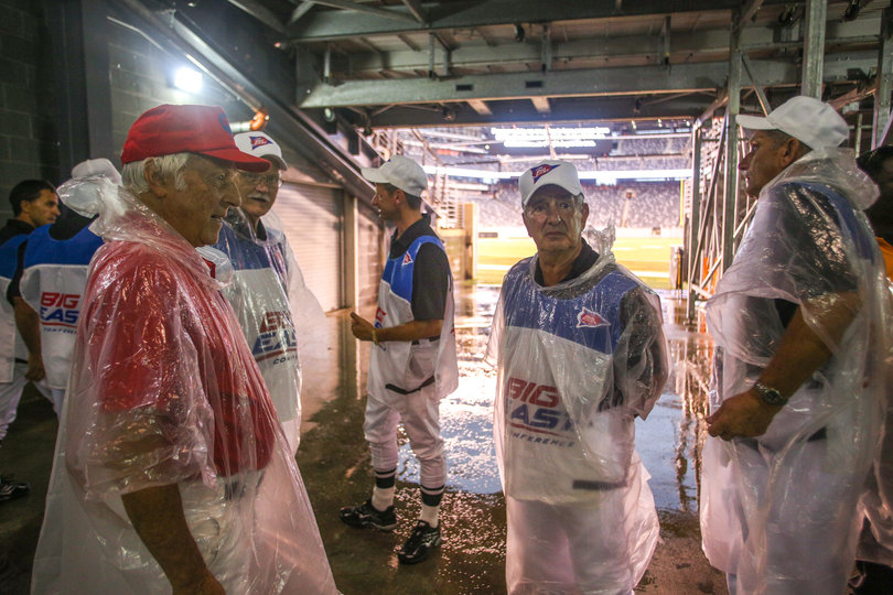 Big East officials wait inside the stadium during a weather delay due to lightning.
