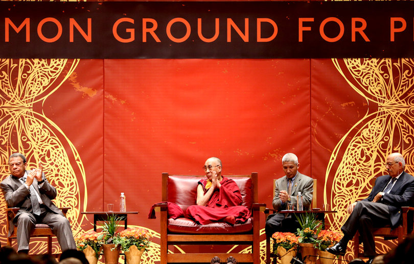 The Dalai Lama listens to the other panelists, as he stated repeatedly that he wants to "learn from them."
