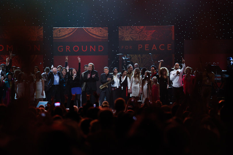 The One World Concert artists wave to the crowd as they conclude their rendition of John Lennon's "Imagine."