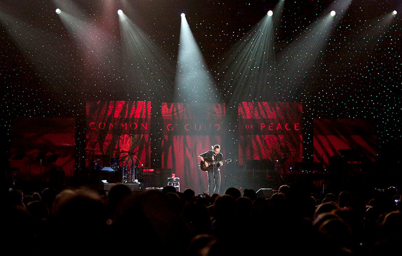 The spotlights shine on Dave Matthews as he performs his set during the One World Concert.