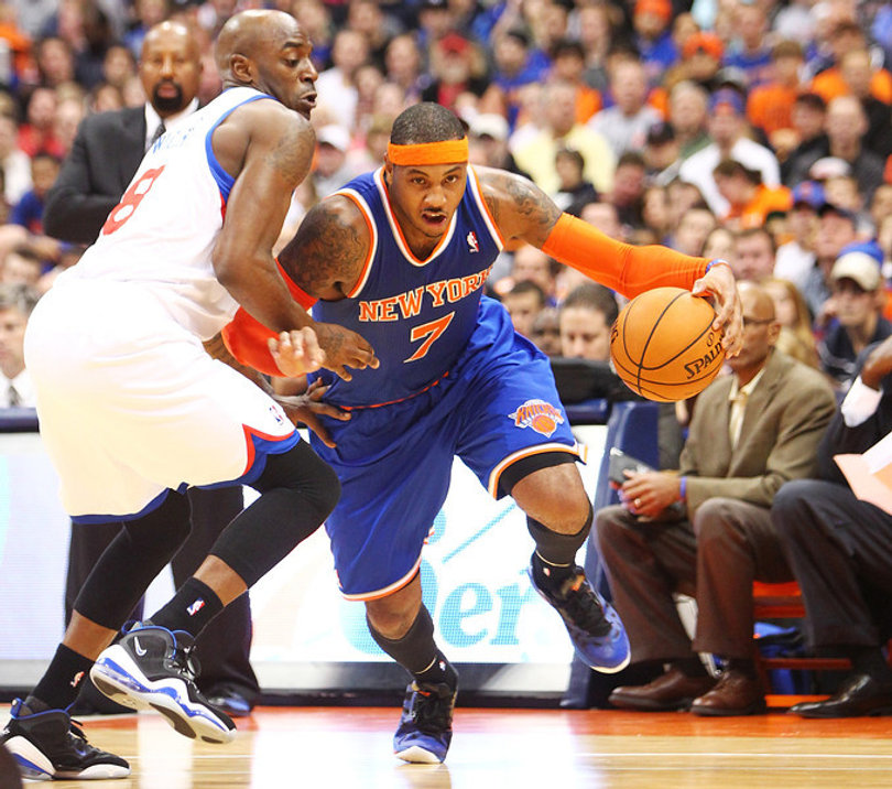 Carmelo Anthony of the New York Knicks drives to the basket against Damien Wilkins of the Philadelphia 76ers.