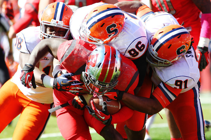 (From left) Syracuse linebacker Siriki Diabate and defensive linemen Jay Bromley and Brandon Sharpe gang tackle Rutgers running back Jawan Jamison. The SU defense held the Big East's leading rusher to 64 yards in the team's 23-15 loss Saturday.