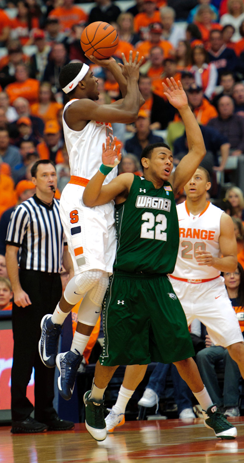 Syracuse forward C.J. Fair shoots over Wagner guard Dwaun Anderson.