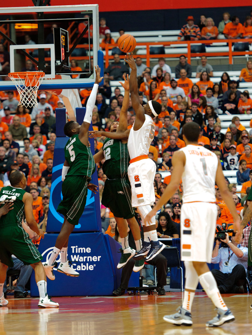 Syracuse forward C.J. Fair tries a baby hook over the Wagner defense.
