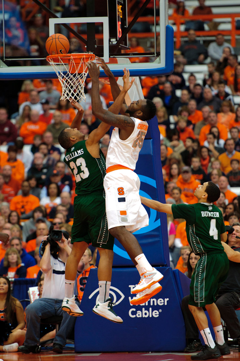 Syracuse forward Rakeem Christmas tries putting the ball in over guard Jonathon Williams.