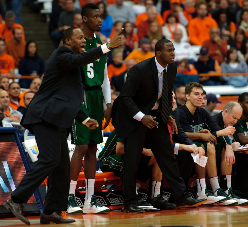Wagner head coach Bashir Mason (left) signals to his team.
