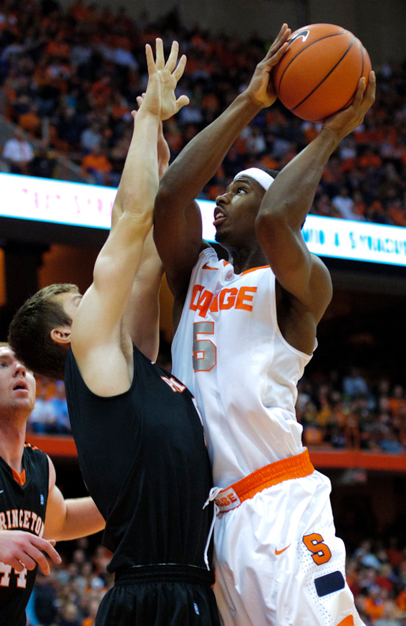 Syracuse forward C.J. Fair leans in to attempt a shot.
