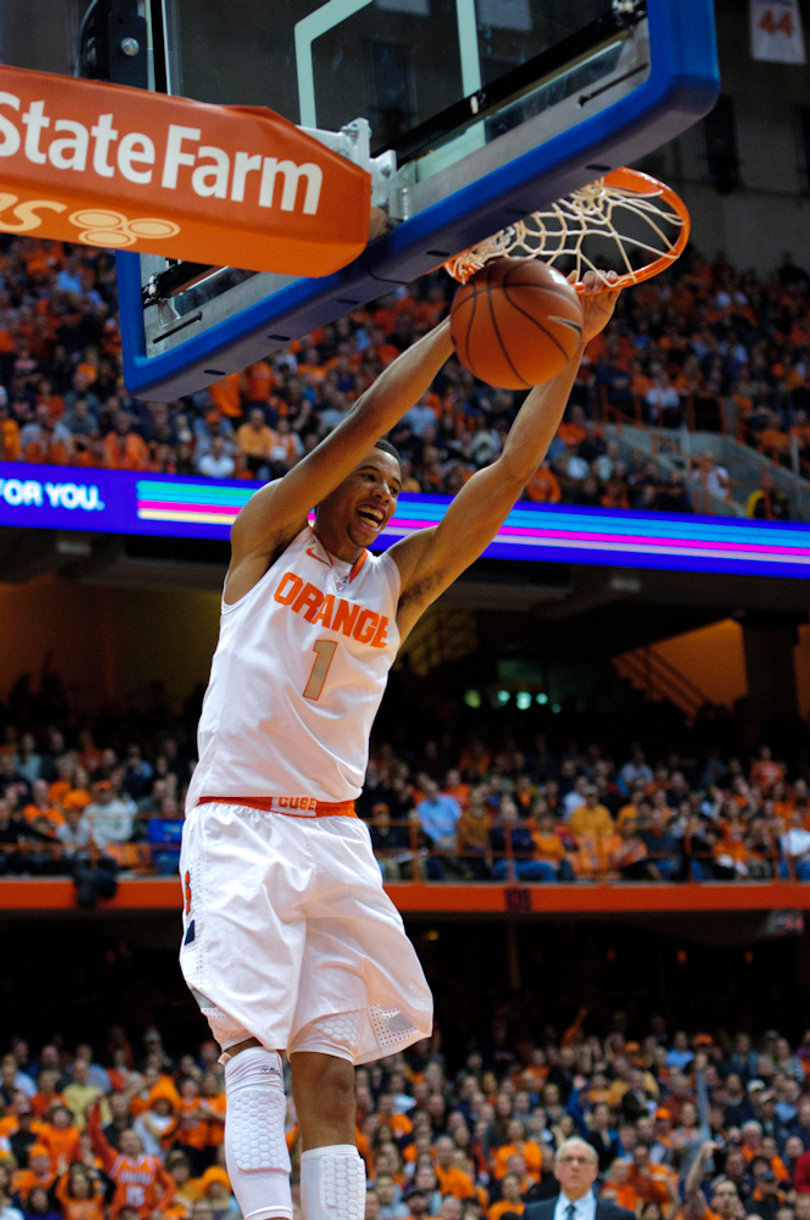 Syracuse guard Michael Carter-Williams puts home a dunk to finish a fast break.