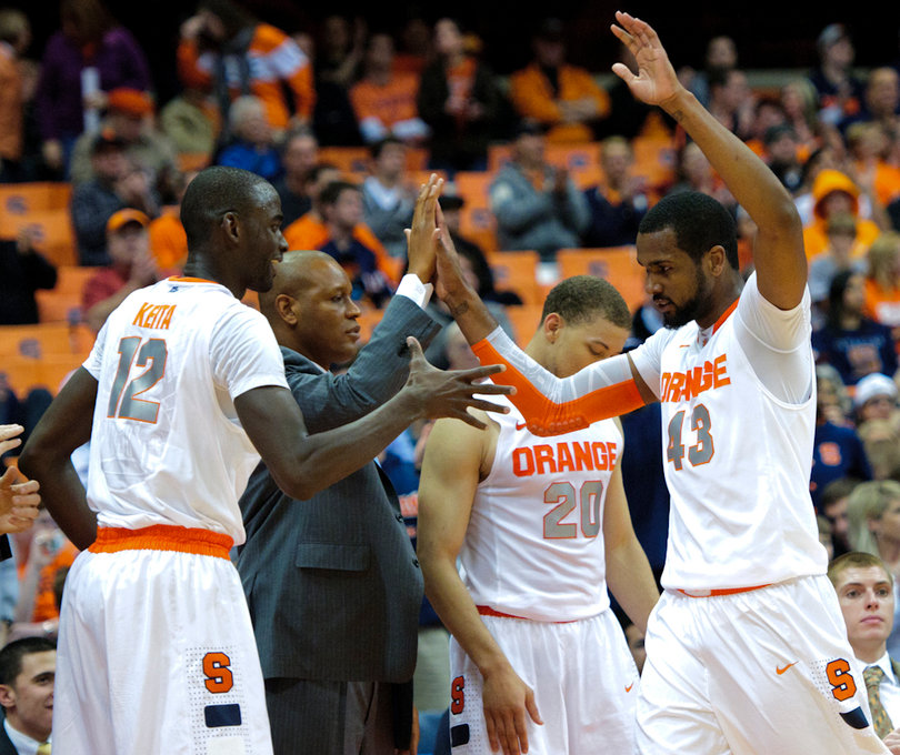 Syracuse forward James Southerland comes off the court and slaps five with teammates.