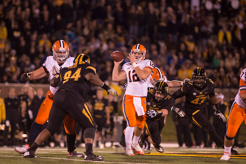 Syracuse quarterback Ryan Nassib looks for a place to throw downfield while trying to avoid pressure.
