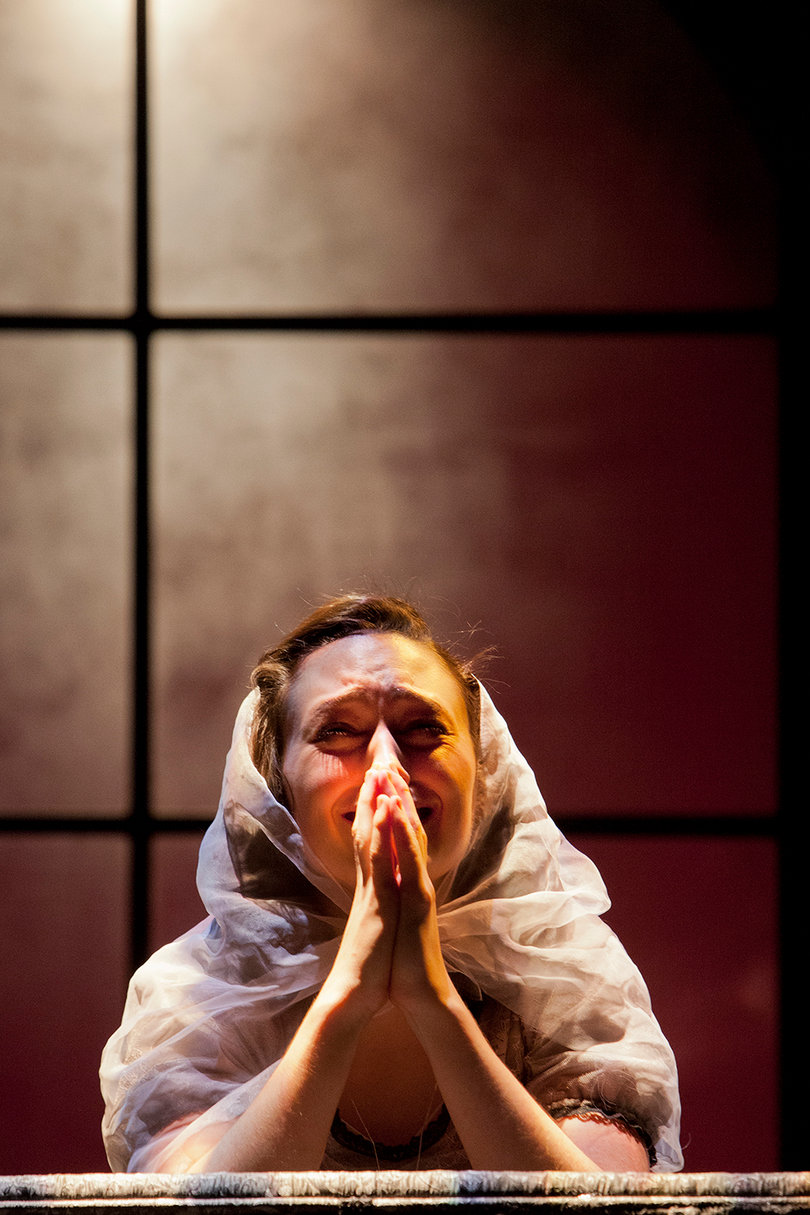 A character drops to her knees in prayer during SU Drama's production of ''Tis Pity She's a Whore." 