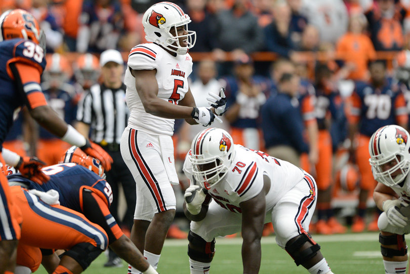 Louisville quarterback Teddy Bridgewater steps away from the line to call a timeout.