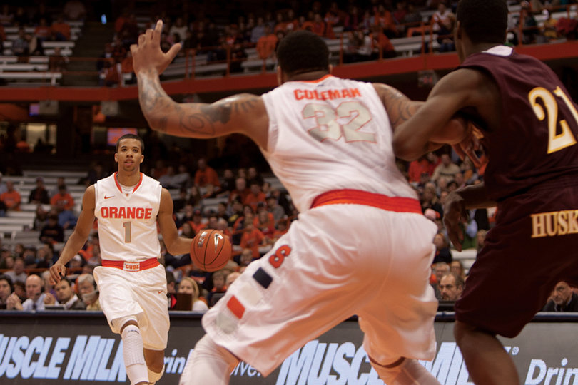 Guard Michael Carter-Williams looks to pass as DaJuan Coleman jockeys for position.