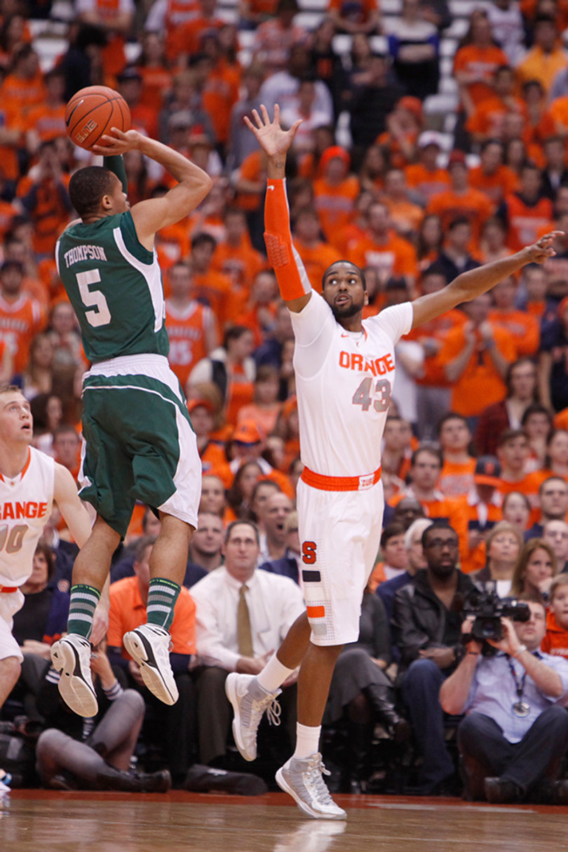 James Southerland leaps in an attempt to block a shot from Eastern Michigan guard Derek Thompson.