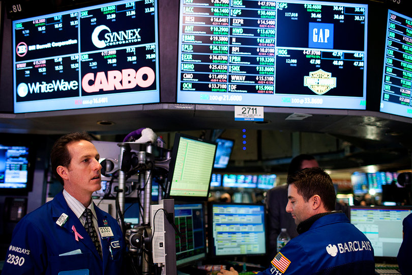 Workers at the NYSE are visited by representatives from the Syracuse and West Virginia football teams.