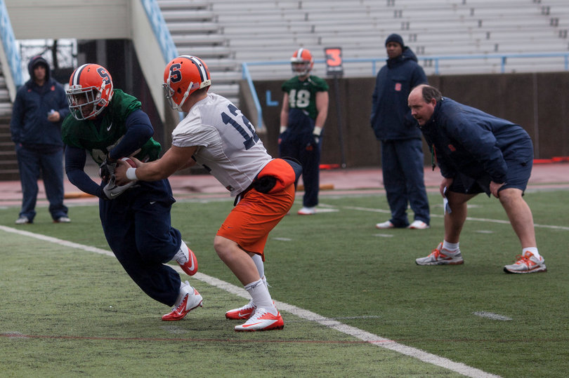 Ryan Nassib hands the ball off to Jerome Smith at practice Thursday.
