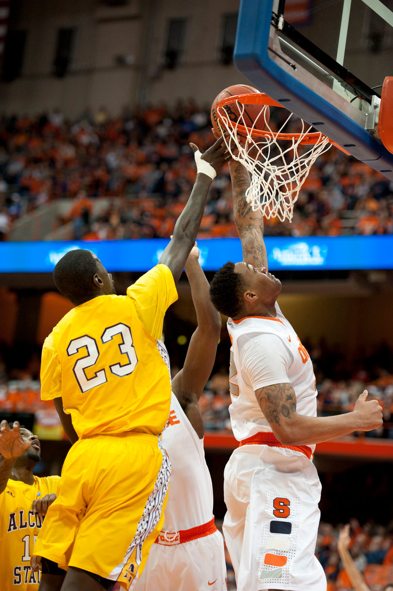 DaJuan Coleman attempts a dunk past Alcorn State forward Josh Nicholas.