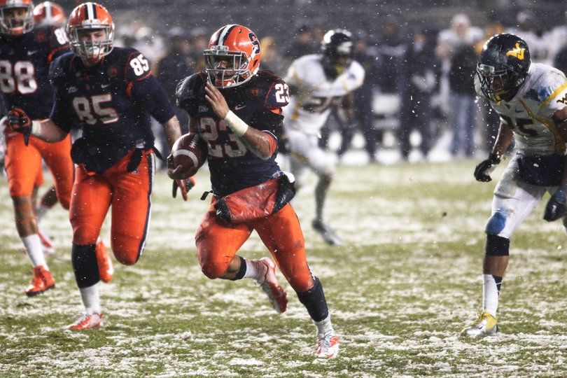 Prince-Tyson Gulley #23, a running back for Syracuse, runs for a touchdown.  Syracuse takes on West Virginia in the 2012 Pinstripe Bowl at a snowy Yankee Stadium on Saturday, December 29, 2012 in New York, New York.