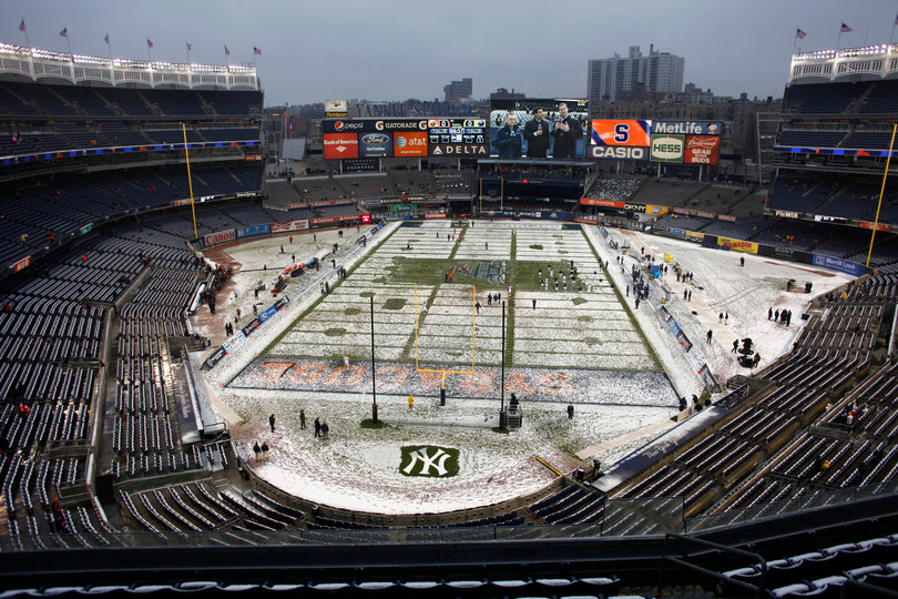 Snow begins to mix with rain, and seats remain empty about an hour before kickoff.  Syracuse takes on West Virginia in the 2012 Pinstripe Bowl at a snowy Yankee Stadium on Saturday, Dec. 29, 2012, in New York City.