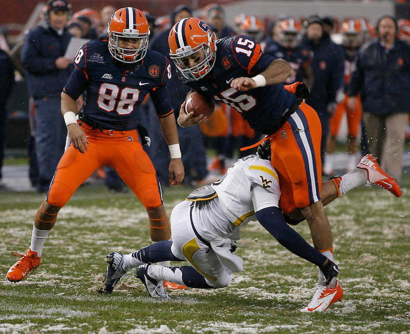 Syracuse wide receiver Alec Lemon #15 is tripped up in the first half.  Syracuse takes on West Virginia in the 2012 Pinstripe Bowl at a snowy Yankee Stadium on Saturday, December 29, 2012 in New York, New York.