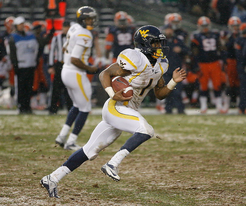 Trevon Austin #1, wide receiver for West Virginia, runs the ball up the field.  Syracuse takes on West Virginia in the 2012 Pinstripe Bowl at a snowy Yankee Stadium on Saturday, December 29, 2012 in New York, New York.