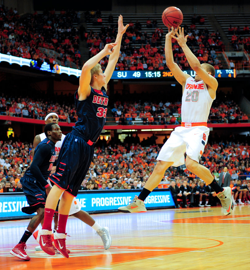 Syracuse guard Brandon Triche takes a jump shot over Detroit's Evan Bruinsma.