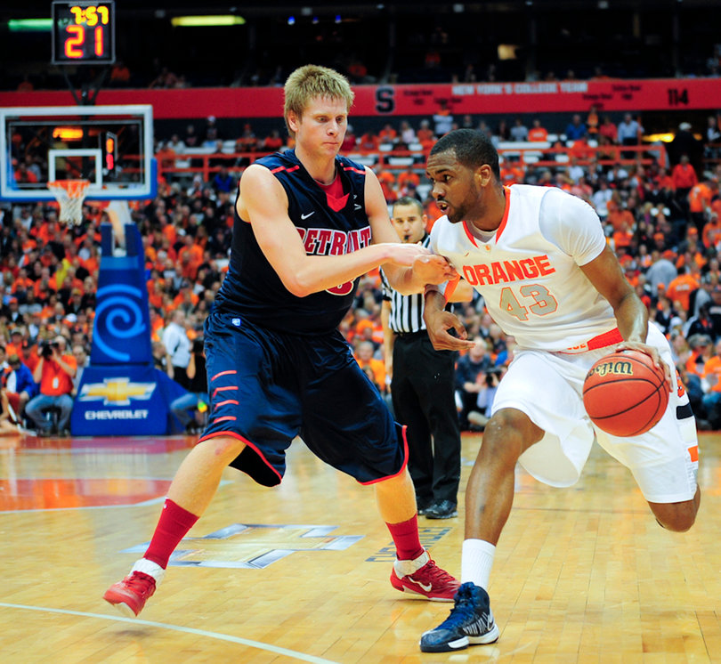Syracuse forward James Southerland runs past Detroit's Evan Bruinsma.