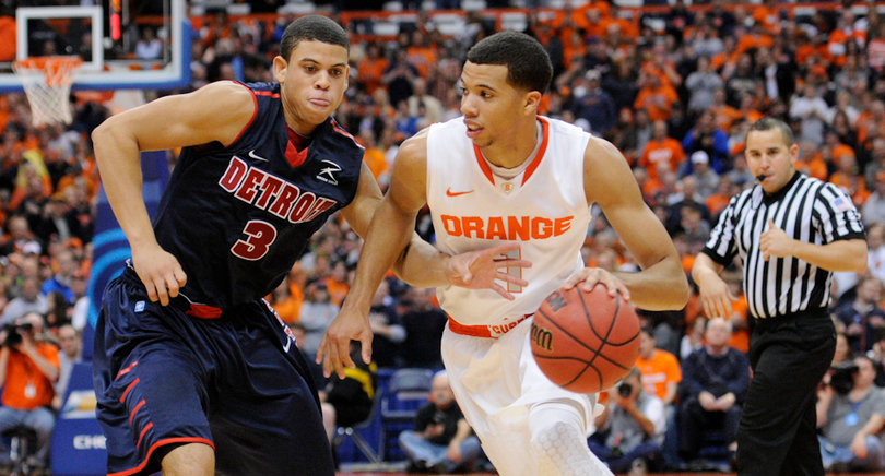 Syracuse guard Michael Carter-Williams looks to break free from Detroit's Ray McCallum.