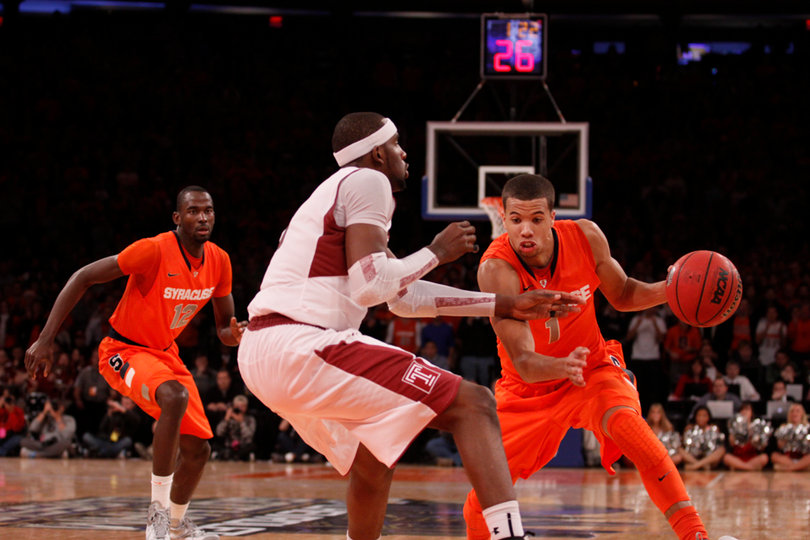 Michael Carter-Williams tries to escape Anthony Lee from the point.