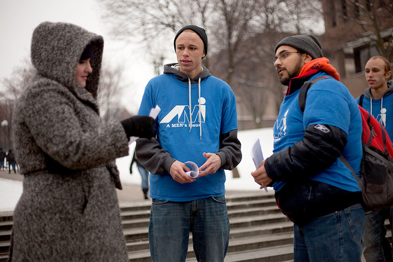 Kari Mccan, Anthony McGriff and Paul Ang, gather on Waverly and South Crouse avenues to discuss the restructuring process within DPS.