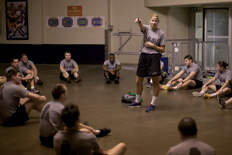 Caitlin Whitmire, a junior psychology, major leads workouts with her battalion Monday morning in the Carrier Dome. 
