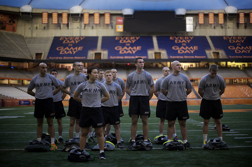 Caitlin Whitmire, a junior psychology major, stands attention in front of her battalion as they are addressed after workouts Monday morning in the Carrier Dome. 