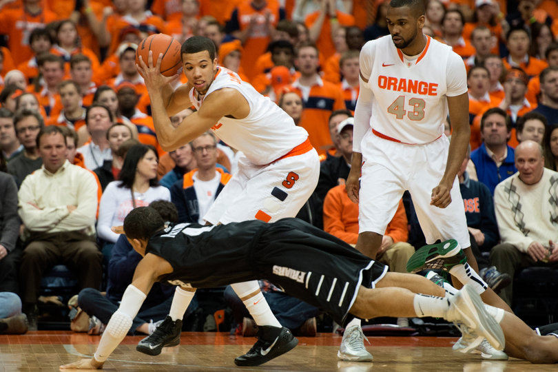 Michael Carter-Williams holds the ball under pressure in Syracuse's 84-59 win against Providence Wednesday night in the Carrier Dome.