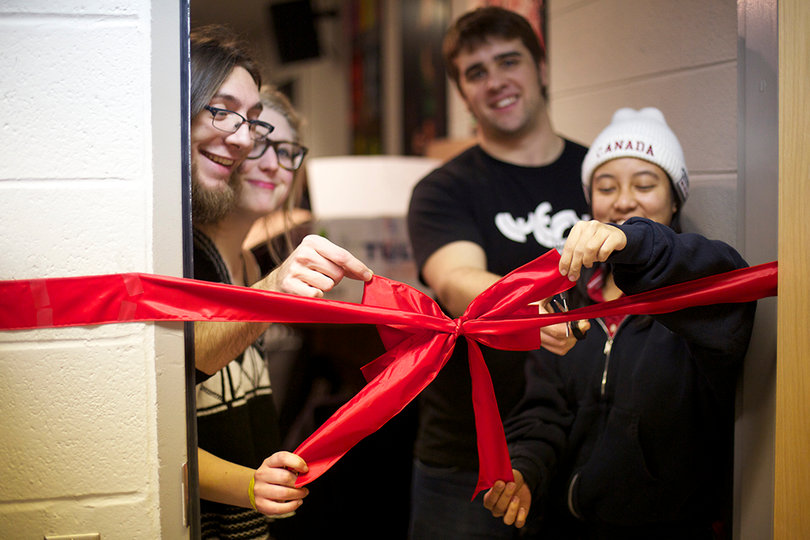 The crew at WERW cuts red tape while celebrating their 25th anniversary. 