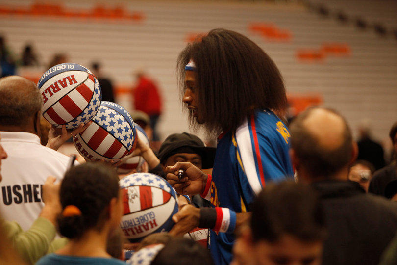 Moose signs autographs for the fans following Friday's championship game, a 114-100 win for the Globetrotters. 