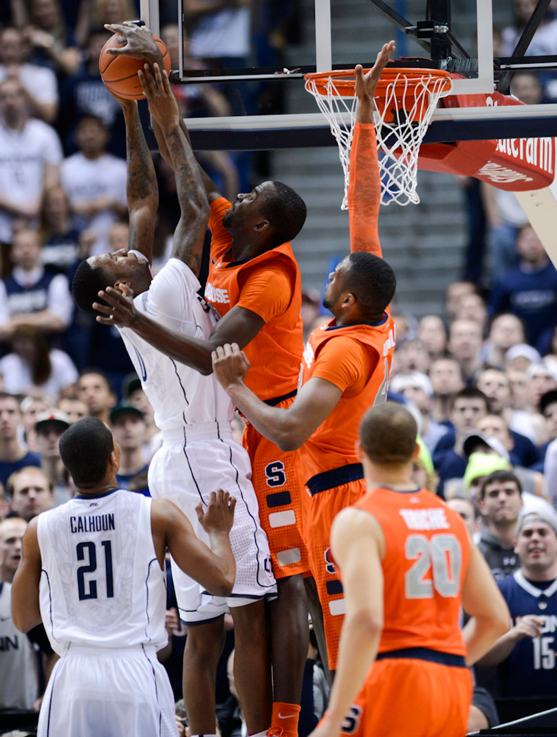 Syracuse center Baye Moussa Keita blocks Connecticut forward Phillip Nolan.