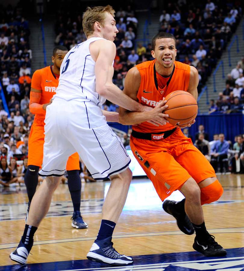 Connecticut swingman Niels Giffey reaches to knock the ball away from Syracuse point guard Michael Carter-Williams.