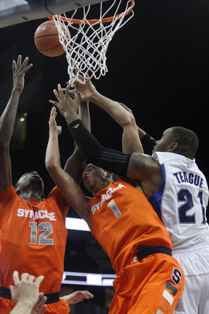 Michael Carter-Williams and Baye Moussa Keita fight Seton Hall's Gene Teague for the ball in the Orange's 76-65 victory at Seton Hall Saturday night.