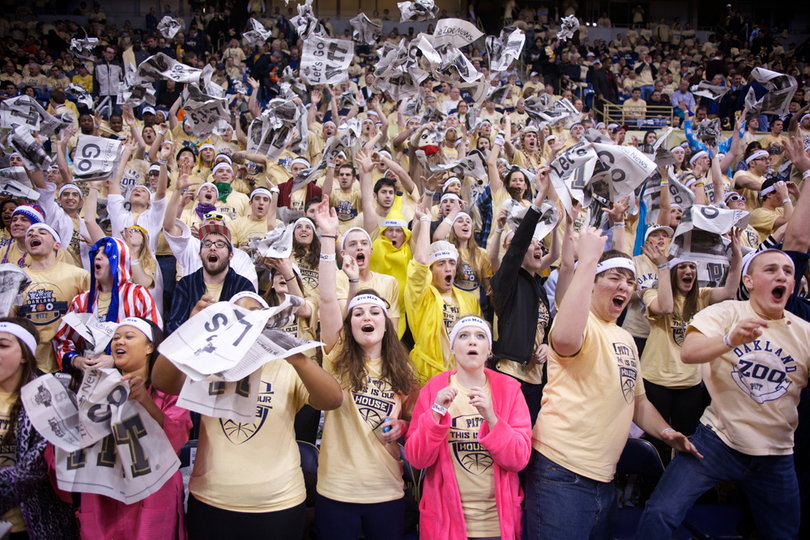 Members of the Pitt "Zoo" throw newspapers prior to tip-off at the Petersen Events Center on Saturday. Pitt defeated the Orange 65-55 in the Big East matchup. 