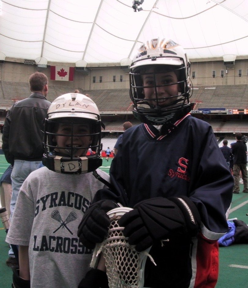 Dylan Maltz, 9 (left) and Derek Maltz, 11 (right) at the Carrier Dome in 2003 for the 20th anniversary of their father's national championship team. Dylan highlights the Orange's 2013 recruiting class.
