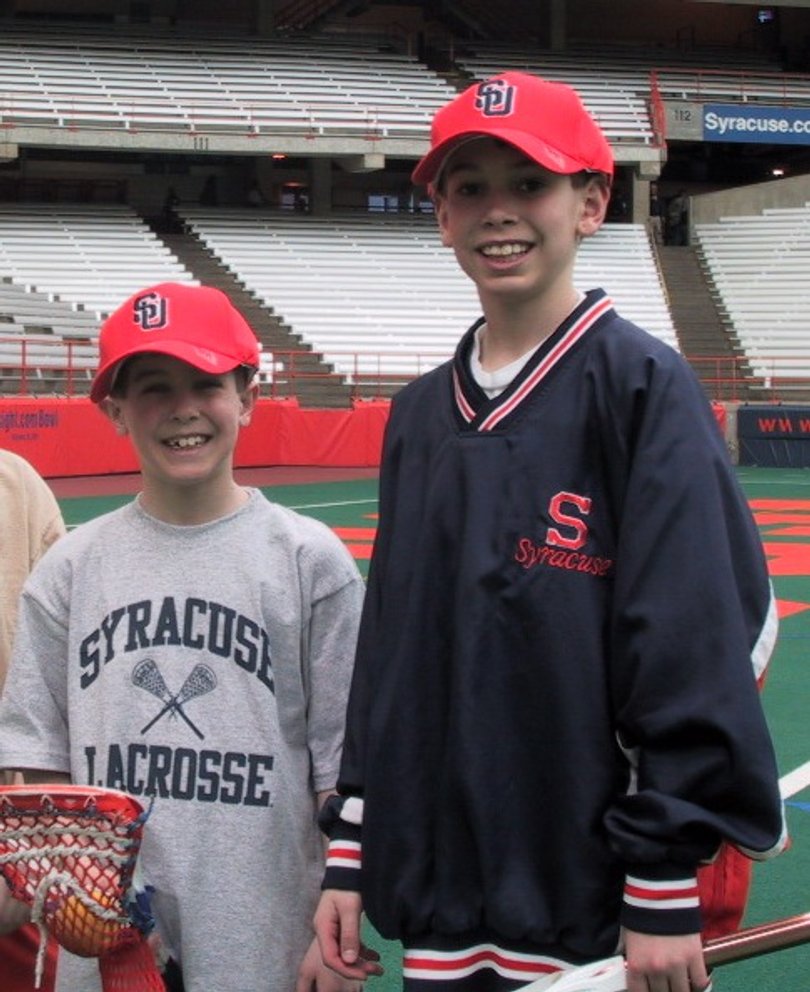Dylan Maltz, 9 (left) and Derek Maltz, 11 (right) working as ball boys in the Carrier Dome in 2003. Their father, Derek Maltz Sr. helped SU to its first NCAA title in 1983.